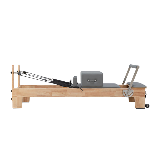 Classic Oak Core Pilates Reformer in grey upholstery – full front view on white background