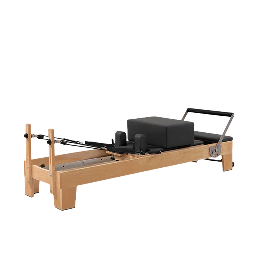 Side view of the Classic Oak Core Pilates Reformer in black, highlighting the oak wood frame and smooth carriage track